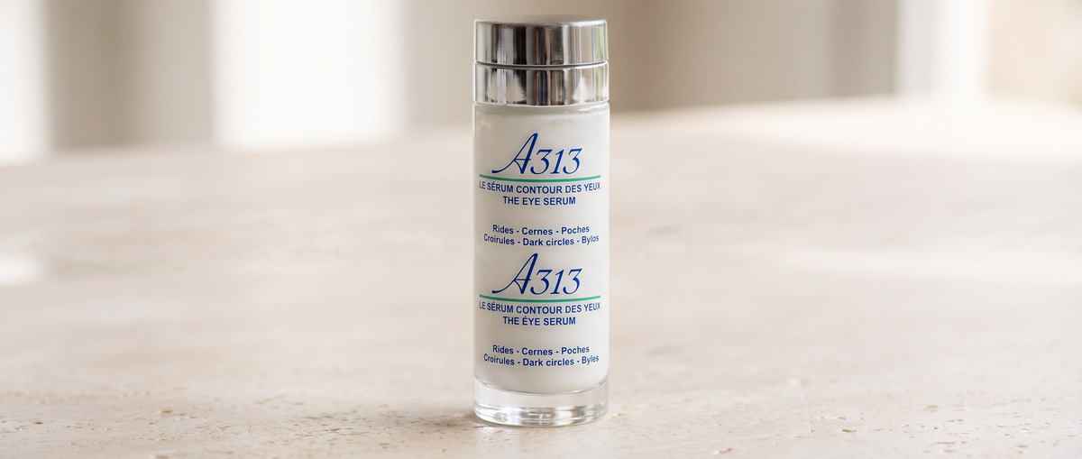 Macro shot of the A313 Eye Serum cap and label in soft daylight, set against a wide, light background