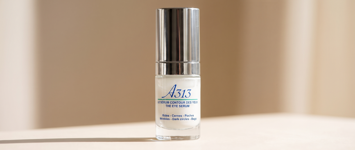 Close-up of the A313 Eye Serum cap and label in soft daylight, widened into a banner